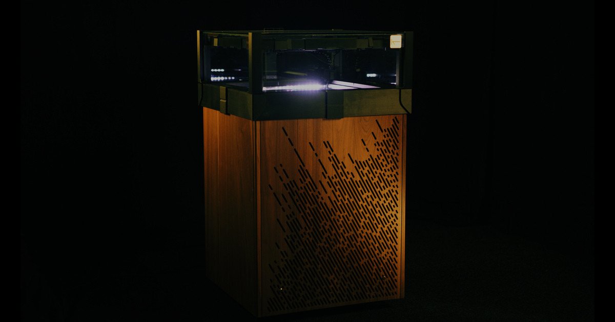 The Kaon Muon:50 cloud chamber, illuminated within a bespoke walnut enclosure.